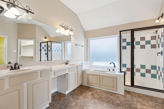 bathroom with lofted ceiling, vanity, and shower with separate bathtub