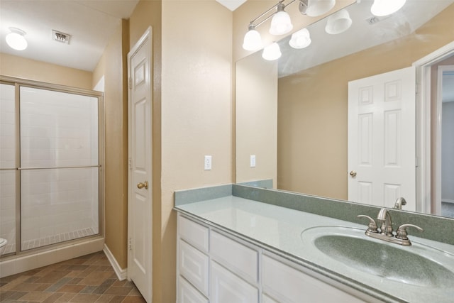 bathroom featuring vanity and a shower with shower door