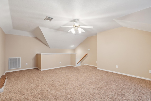 bonus room with ceiling fan, carpet flooring, and vaulted ceiling