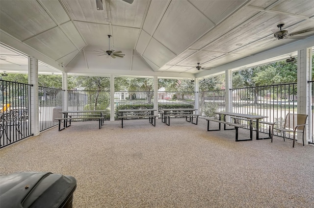 sunroom / solarium featuring a water view, ceiling fan, and lofted ceiling