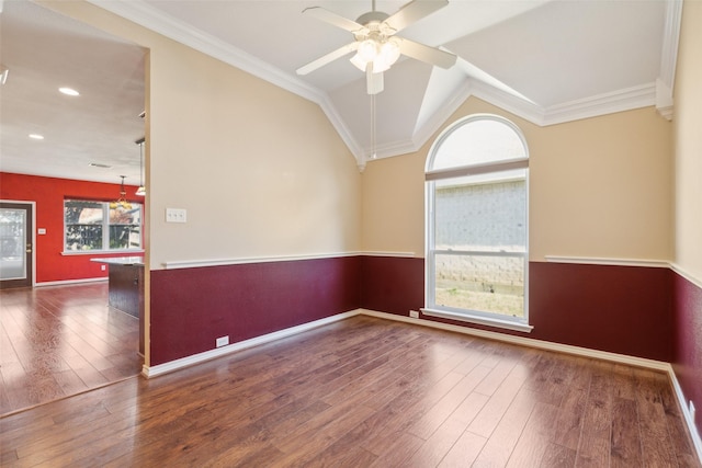 empty room featuring dark wood-type flooring, ceiling fan, lofted ceiling, and crown molding