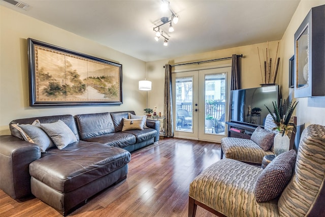 living room featuring french doors, hardwood / wood-style floors, and rail lighting