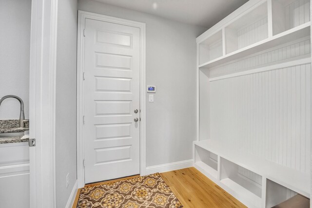 mudroom with hardwood / wood-style flooring and sink