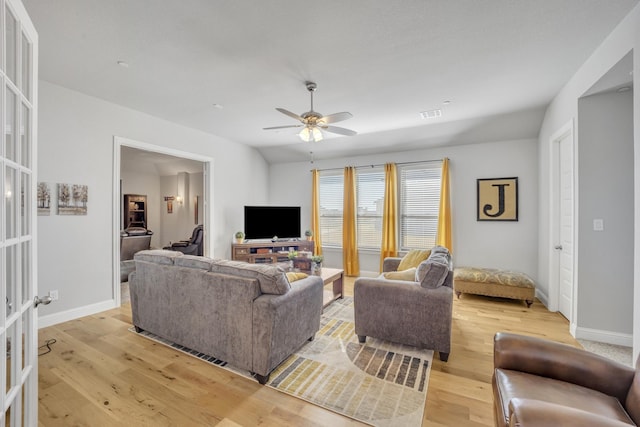 living room with french doors, light hardwood / wood-style floors, vaulted ceiling, and ceiling fan