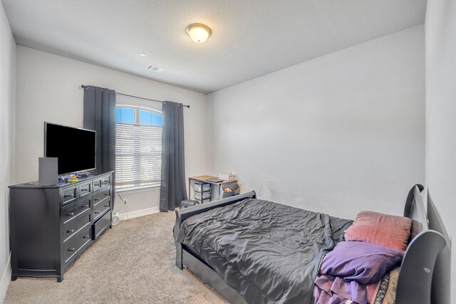 bedroom with light colored carpet