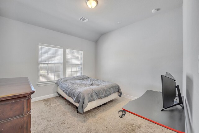 carpeted bedroom featuring lofted ceiling