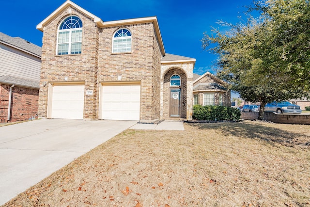 view of property featuring a front yard and a garage