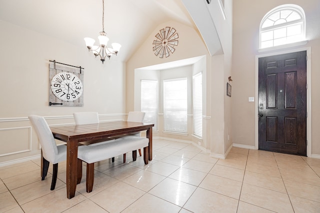 dining room featuring high vaulted ceiling, light tile patterned floors, a notable chandelier, and plenty of natural light