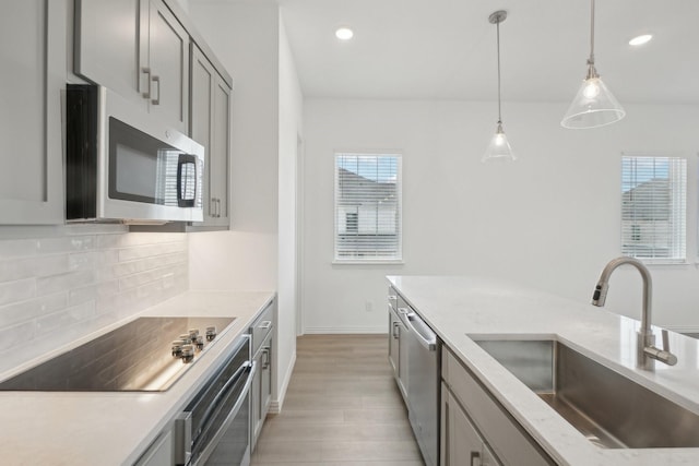 2402 Bulin Dr, Mansfield, TX 76063 - kitchen with recessed lighting, tasteful backsplash, appliances with stainless steel finishes, a sink, and decorative light fixtures