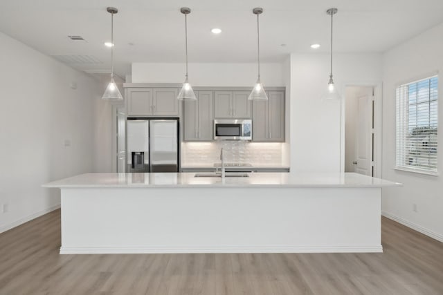 2402 Bulin Dr, Mansfield, TX 76063 - kitchen featuring light countertops, stainless steel appliances, a sink, gray cabinetry, and backsplash