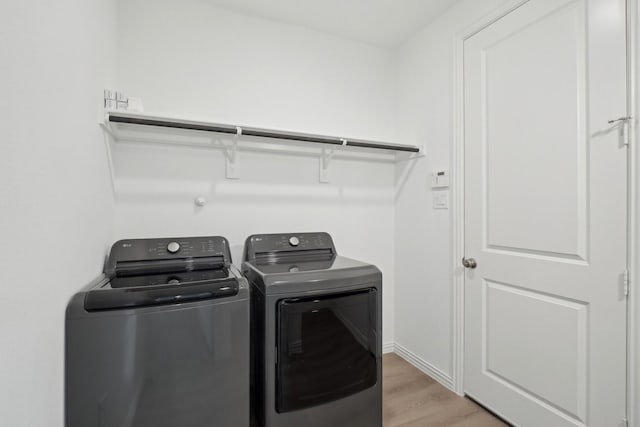2402 Bulin Dr, Mansfield, TX 76063 - laundry area featuring baseboards, independent washer and dryer, laundry area, and light wood-type flooring