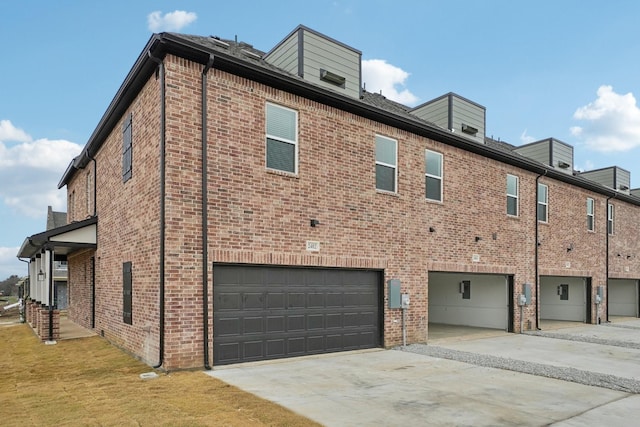 2402 Bulin Dr, Mansfield, TX 76063 - view of side of property with brick siding, driveway, and a garage