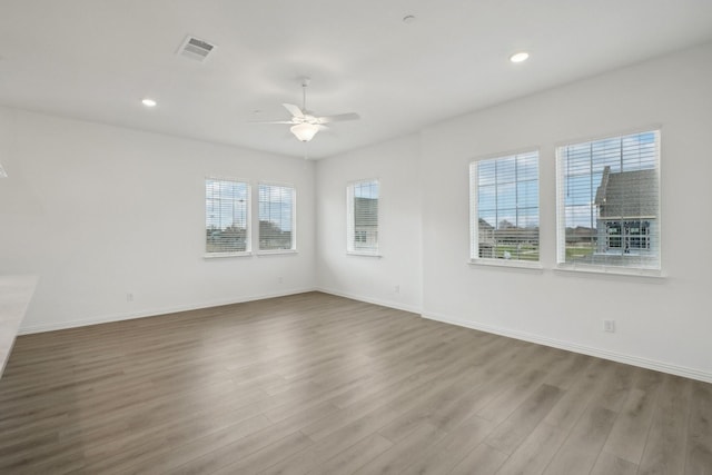 2402 Bulin Dr, Mansfield, TX 76063 - empty room with wood finished floors, visible vents, a healthy amount of sunlight, and ceiling fan