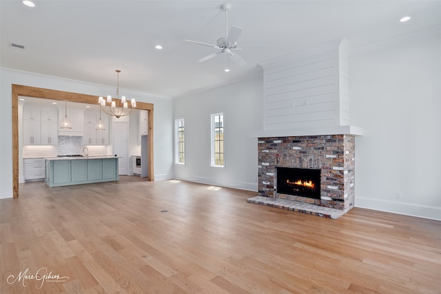 2129 Pecan Square Ave, Shreveport, LA 71106 - unfurnished living room with ornamental molding, light wood finished floors, baseboards, a chandelier, and a fireplace