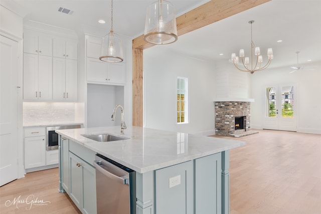 2129 Pecan Square Ave, Shreveport, LA 71106 - kitchen featuring stainless steel dishwasher, recessed lighting, open floor plan, white cabinets, and light wood-style floors