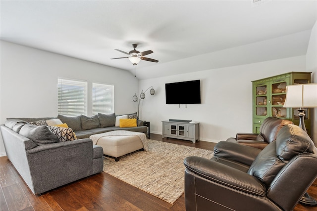 living room with ceiling fan, dark hardwood / wood-style flooring, and vaulted ceiling