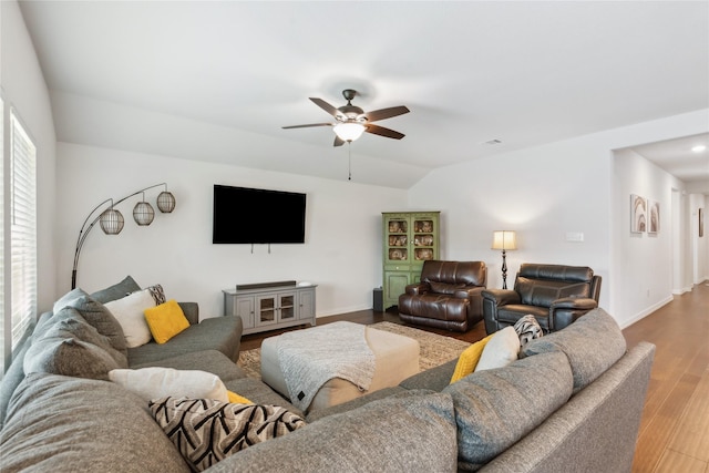 living room with hardwood / wood-style floors, ceiling fan, and lofted ceiling