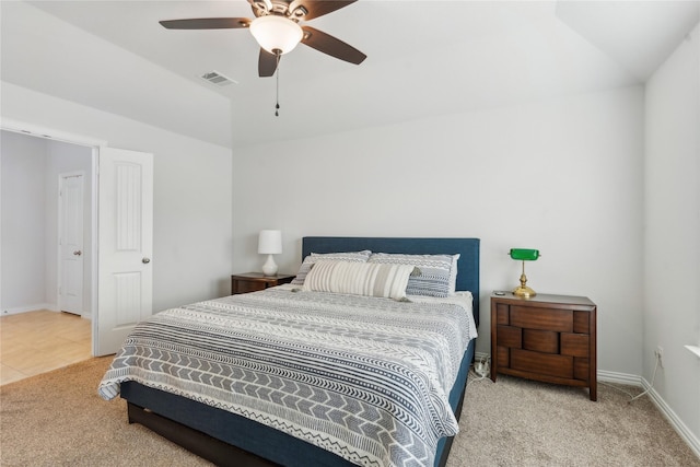 bedroom featuring ceiling fan, light carpet, and vaulted ceiling