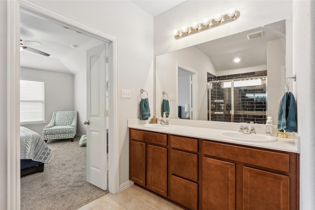 bathroom with vanity, vaulted ceiling, tile patterned flooring, ceiling fan, and walk in shower