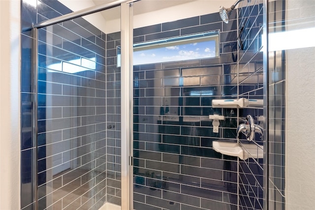 bathroom with a tile shower