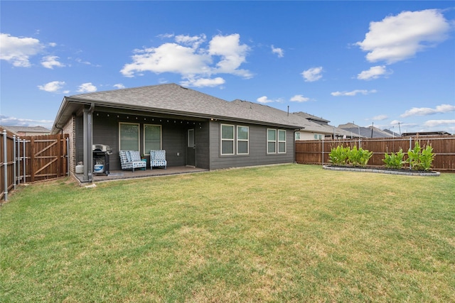 rear view of property featuring a yard and a patio