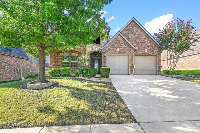 front of property featuring a front yard and a garage