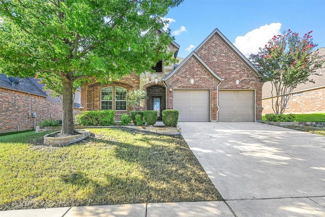 front of property with a garage and a front lawn