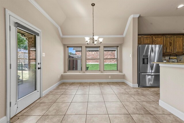 kitchen featuring ceiling fan with notable chandelier, tasteful backsplash, hanging light fixtures, a center island, and stainless steel appliances