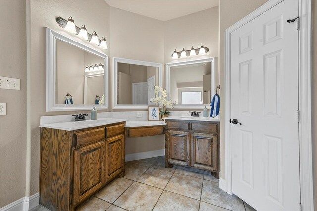 bathroom featuring vanity, tile patterned flooring, vaulted ceiling, and a tub