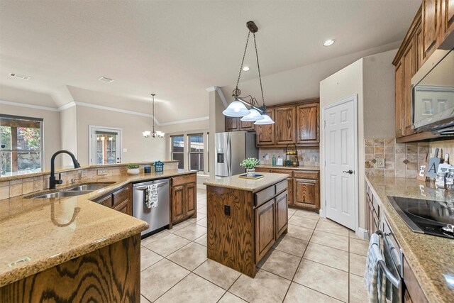 kitchen featuring sink, hanging light fixtures, a center island, stainless steel appliances, and crown molding