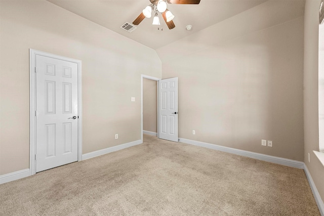 empty room with ceiling fan and light carpet