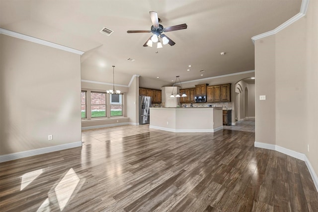 unfurnished living room with wood-type flooring, ceiling fan with notable chandelier, and ornamental molding