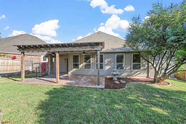 rear view of property featuring ceiling fan, a pergola, a patio, and a lawn