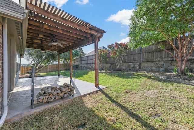 view of yard featuring ceiling fan and a patio