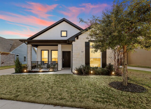 view of front of home featuring a lawn and covered porch