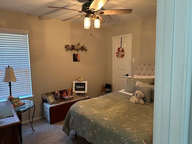 bedroom with ceiling fan and carpet floors