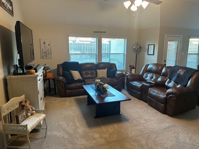 living room featuring light carpet, ceiling fan, and lofted ceiling