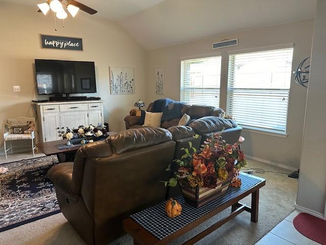 living room featuring ceiling fan, light colored carpet, and lofted ceiling