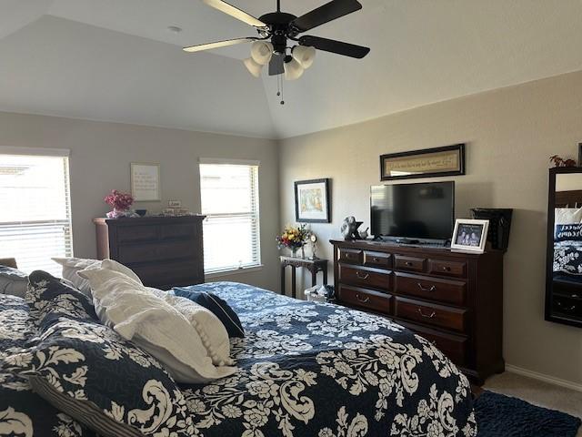 bedroom with carpet floors, ceiling fan, and lofted ceiling