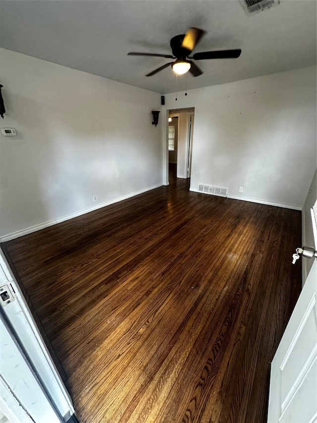 spare room with hardwood / wood-style flooring and ceiling fan