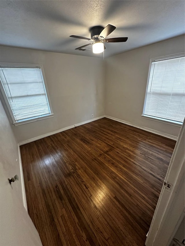 unfurnished room featuring ceiling fan and dark hardwood / wood-style flooring