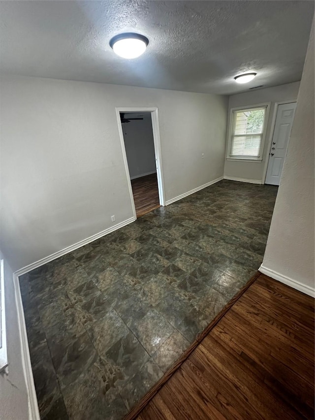 empty room with a textured ceiling