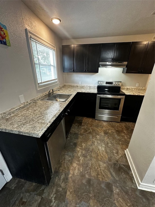 kitchen with stainless steel appliances, light stone counters, and sink