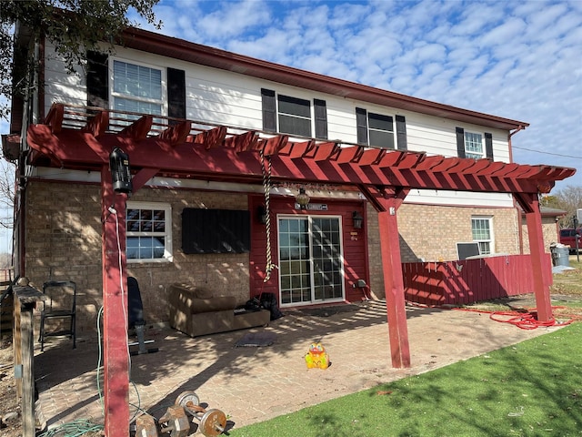 back of property featuring a patio area, brick siding, and a pergola