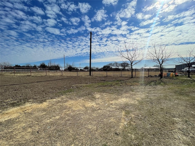 view of yard with a rural view and fence