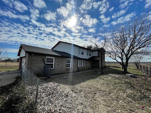 rear view of property with a garage