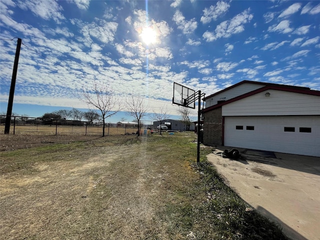 exterior space with a garage, an outdoor structure, and fence