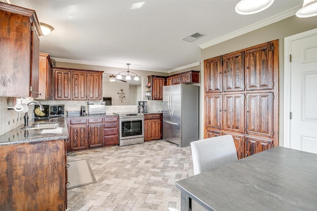 kitchen with sink, hanging light fixtures, crown molding, decorative backsplash, and appliances with stainless steel finishes