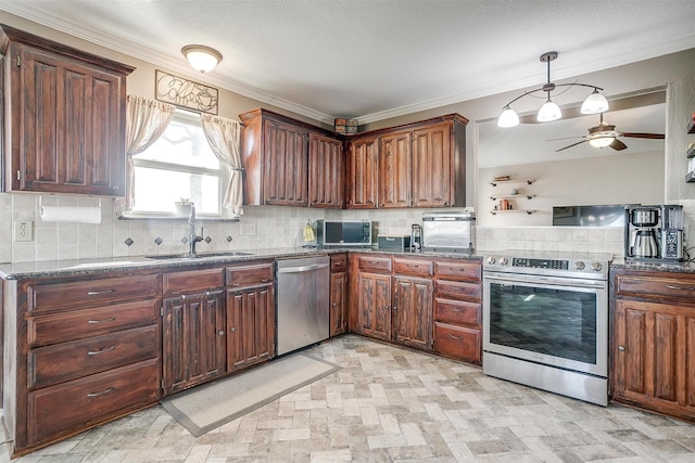 kitchen featuring backsplash, sink, appliances with stainless steel finishes, and dark stone counters