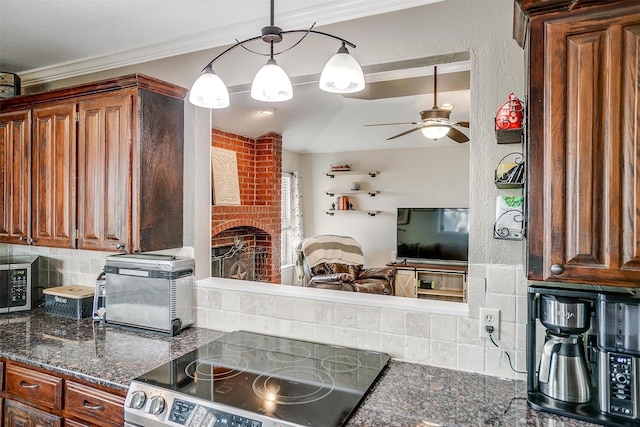 kitchen featuring stove, ceiling fan, ornamental molding, tasteful backsplash, and decorative light fixtures